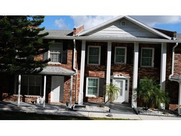 Brick front of a two-story townhome with a covered entryway at 5850 Cypress Gardens Blvd # 304, Winter Haven, FL 33884