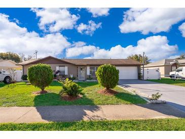 House exterior featuring a well-maintained lawn and shrubs at 2825 Beal St, Deltona, FL 32738