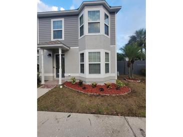 Two-story house with gray siding, landscaping, and a front entrance at 4530 Brook Hollow Cir, Winter Springs, FL 32708