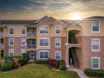 Tan two-story building with stairs and landscaping at 580 Brantley Terrace Way # 203, Altamonte Springs, FL 32714