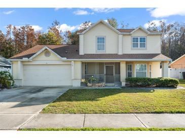 Two-story house with attached garage and landscaped lawn at 112 Blackwater Ct, Kissimmee, FL 34743