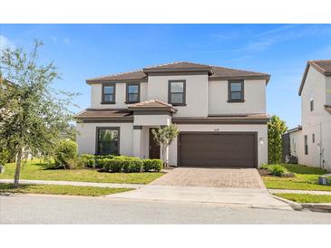 Two-story house with a brown door and garage at 218 Brooke'S Pl, Haines City, FL 33844