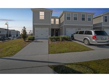 Two-story townhouse with driveway and garage at 251 Blueberry Ln, Davenport, FL 33837