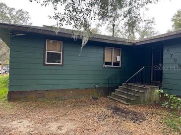 Green house exterior with steps leading to the entrance at 2732 Westside Dr, Leesburg, FL 34748