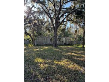 Mobile home with deck, situated on a spacious lot with mature trees at 15924 Old Cheney Hwy, Orlando, FL 32833