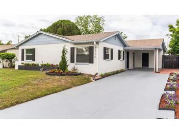 Updated single-story home with a paved driveway and well-maintained landscaping at 4314 Prince Hall Blvd, Orlando, FL 32811