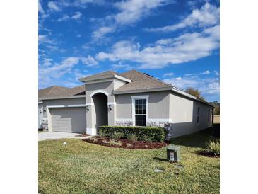 One-story home with attached garage and landscaped lawn at 3509 Yarian Dr, Haines City, FL 33844