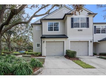 Two-story townhome with attached two-car garage and landscaped front yard at 6292 Twain St # 101, Orlando, FL 32835