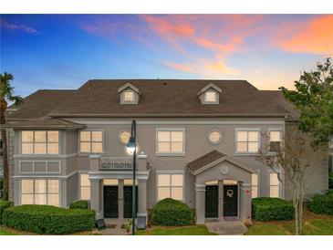 Attractive two-story townhome with a charming front porch and landscaping at 5269 Wellington Park Cir # 23, Orlando, FL 32839