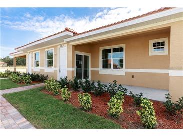 Newly constructed home with attractive landscaping and covered patio at 1782 Coriander Dr, Kissimmee, FL 34759