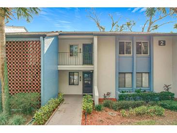 Two-story condo building with light blue exterior and walkway at 2 Escondido Cir # 190, Altamonte Springs, FL 32701