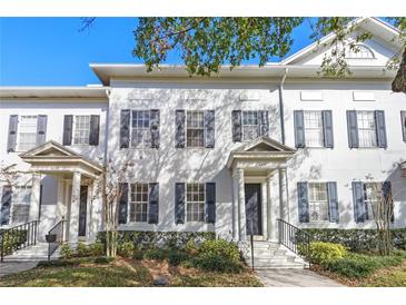 White townhouses with gray shutters and columns at 4459 Twinview Ln, Orlando, FL 32814