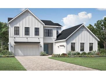 Two-story farmhouse with white siding, black windows, and a three-car garage at 9604 English Laurel, Orlando, FL 32827