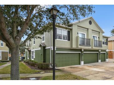 Green two-story townhome with two-car garage and landscaping at 1473 Broken Oak Dr # C, Winter Garden, FL 34787