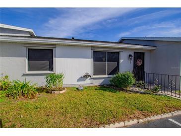 Front view of a condo with well-maintained landscaping at 79 Lake Villa Way, Kissimmee, FL 34743
