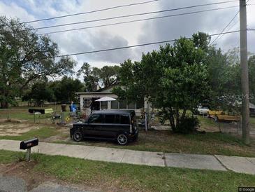 Ranch-style house with a spacious yard and mature trees at 1813 Robinson Dr, Haines City, FL 33844