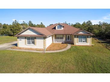Single-story home with a large yard and driveway at 10181 Sw 46 Ct, Ocala, FL 34476