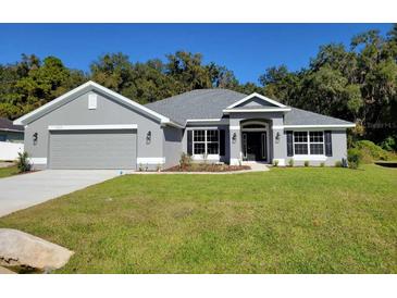 Modern two-story house with gray exterior and two-car garage at 7830 Sw 103Rd Loop, Ocala, FL 34476