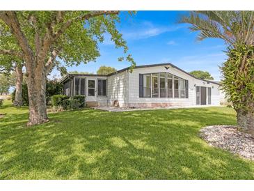 Charming single-wide manufactured home with a spacious yard at 1618 Cypress Pt, Lady Lake, FL 32159