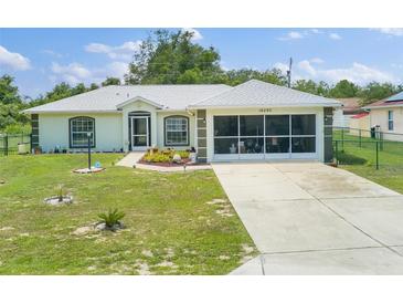 House exterior with screened garage and driveway at 16290 Sw 17Th Ave, Ocala, FL 34473