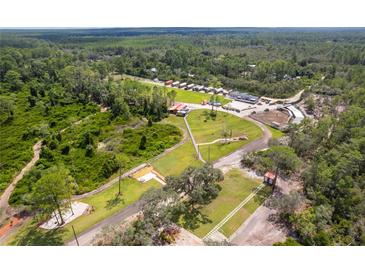 Aerial view of a vast property with various buildings and landscaping at 14181 Se 211Th Court, Umatilla, FL 32784