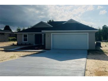 Newly built home with a two-car garage and spacious driveway at 7063 Sw 64Th Ter, Ocala, FL 34476