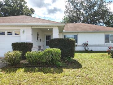 Charming one-story home with well manicured landscaping and attached garage at 5958 Sw 102Nd Ln, Ocala, FL 34476