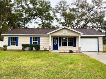 Charming single story home with blue shutters and a white garage door at 3011 Nw 3Rd Ter, Ocala, FL 34475