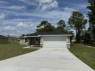 Newly built home with a two-car garage and driveway at 12 Pecan Run Radl, Ocala, FL 34472