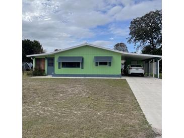 Light green single-story home with carport at 10300 Sw 98Th Ter, Ocala, FL 34481