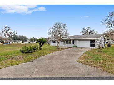 Single-story home with a long driveway and mature landscaping at 10881 Sw 79Th Ter, Ocala, FL 34476