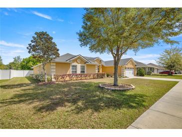 Single-Gathering home with a two-car garage and manicured lawn at 4725 Sw 62Nd St, Ocala, FL 34474