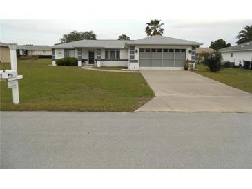 Single-story home with attached garage and driveway at 9951 Sw 62Nd Ter, Ocala, FL 34476
