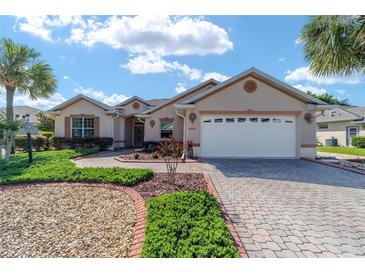Single-Gathering home with 2-car garage and well-manicured landscaping at 8678 Sw 83Rd Cir, Ocala, FL 34481
