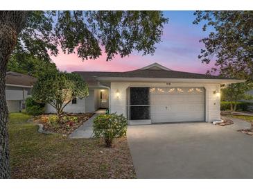 Single story home with white brick exterior and two car garage at 9145 Sw 90Th St, Ocala, FL 34481