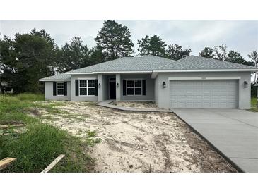 One-story home with gray siding, black shutters, and two-car garage at 11600 Sw 55Th Ave, Ocala, FL 34476