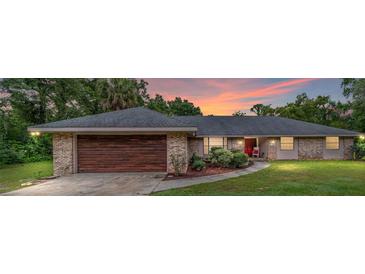 Brick ranch home with dark brown garage door at 5240 Se 17Th St, Ocala, FL 34471