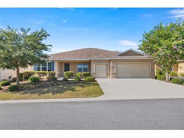 Single-story home with two-car garage and landscaped yard at 10145 Sw 89Th Loop, Ocala, FL 34481