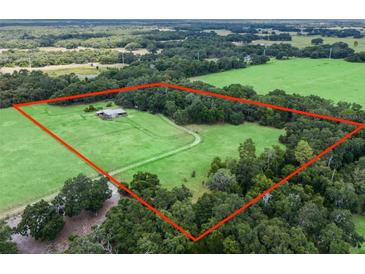 Aerial view of a house on a large lot with green pastures at 4344 Cr 542H, Bushnell, FL 33513