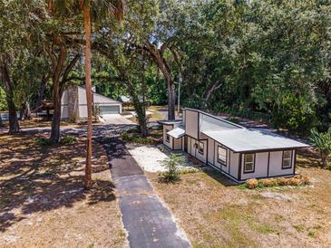 Aerial view of two houses and a long driveway at 14260 Ne 40Th Ct, Anthony, FL 32617