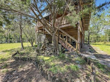 Two-story house with a wooden exterior and landscaped yard at 5401 Se 162Nd St # 32, Summerfield, FL 34491