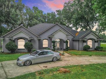 Beautiful home with a large driveway and lush landscaping at 6615 Se 158Th Pl # 6, Summerfield, FL 34491