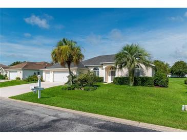 Single-story home with a two-car garage and attractive landscaping at 2260 Nw 51St Ter, Ocala, FL 34482
