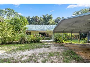 Single-story home with carport and landscaping at 7679 S Magnolia Ave, Ocala, FL 34476