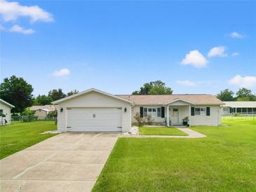 Single-story home with attached garage and spacious lawn at 6248 Sw 103Rd Street Rd, Ocala, FL 34476