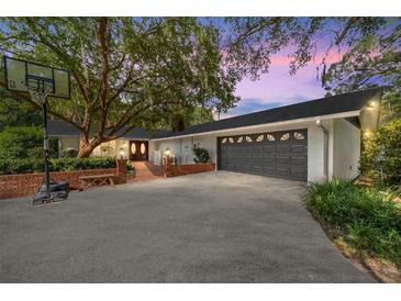 Stunning curb appeal, two-car garage, and mature landscaping at 2305 Se 8Th St, Ocala, FL 34471