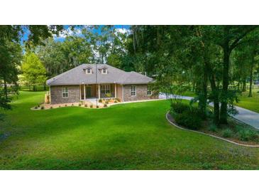 One-story home with stone exterior and large yard at 1989 Nw 111Th Loop, Ocala, FL 34475