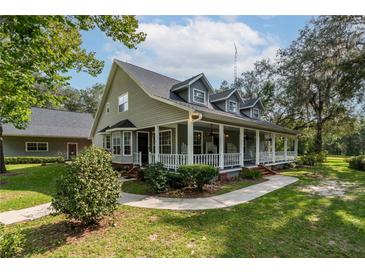 Two-story house with a large front porch at 7545 Ne 58Th Ave, Anthony, FL 32617