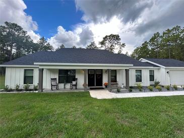 Modern farmhouse exterior with covered porch at 1965 County Road 243C, Wildwood, FL 34785
