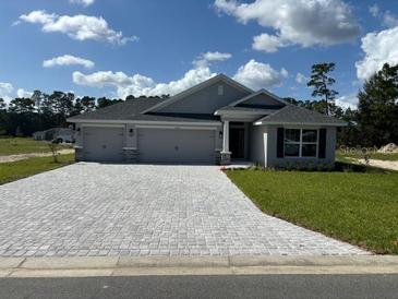 Newly built home with three-car garage and stone accents at 7160 Sw 179Th Court Rd, Dunnellon, FL 34432
